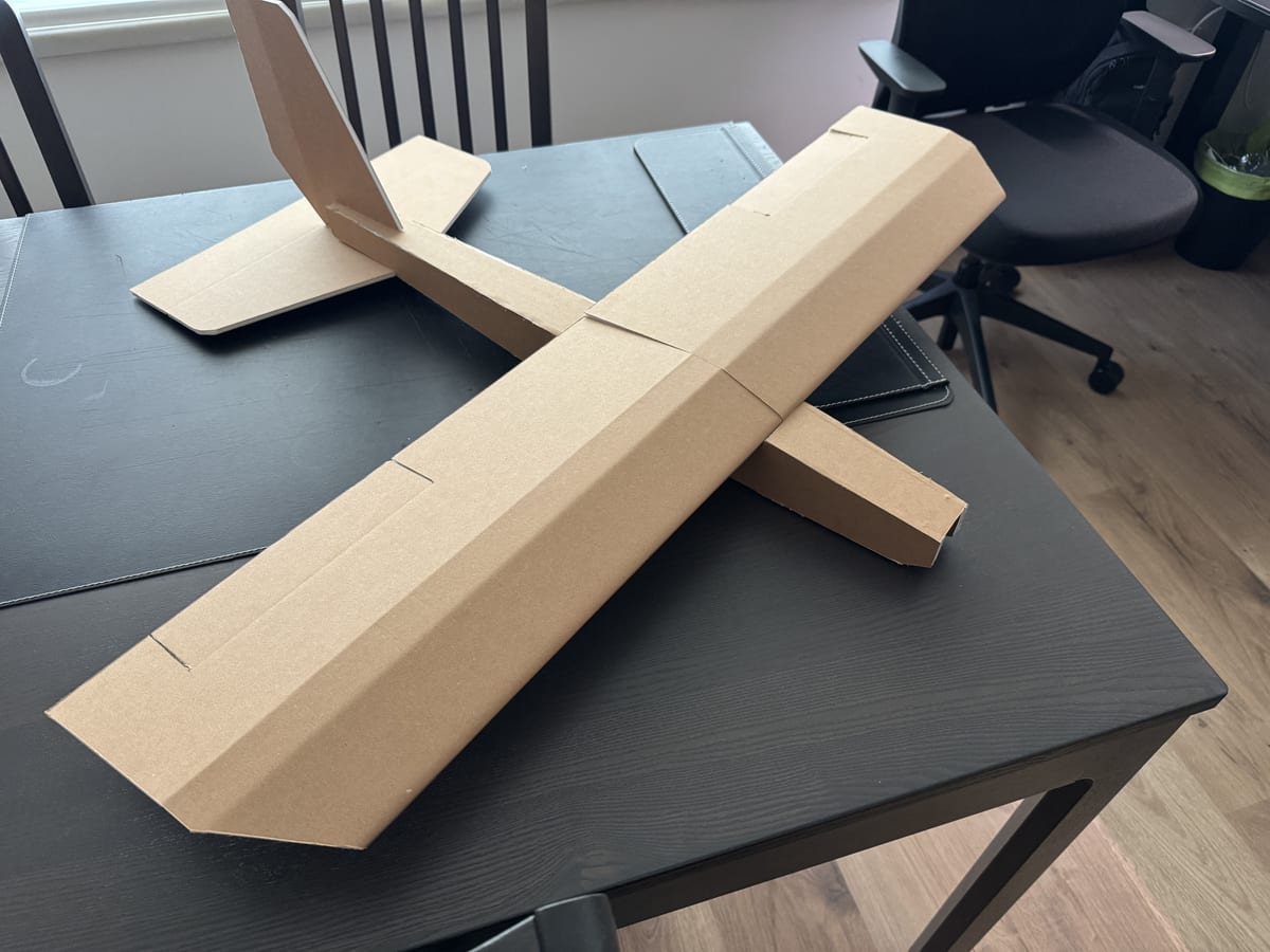 A small fixed-wing aircraft made of foam board faced with card